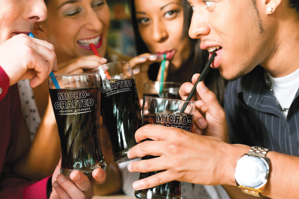 Friends drinking soda in a bar